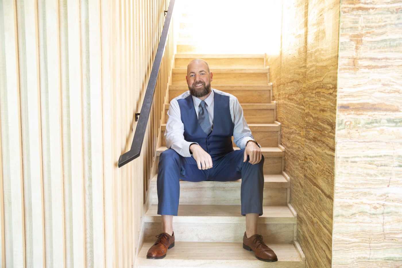 Dalton Locke seated on stone stairs, light pouring from above